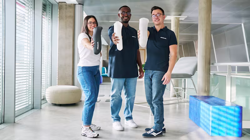 Three Ottobock team member holding Ottobock liners