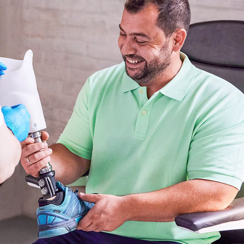 A prosthetic user holds and admires the Ottobock C-Leg 4