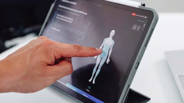 A person interacting with Ottobock software where they can customize a 3D model's measurements and physical conditions to their patient's