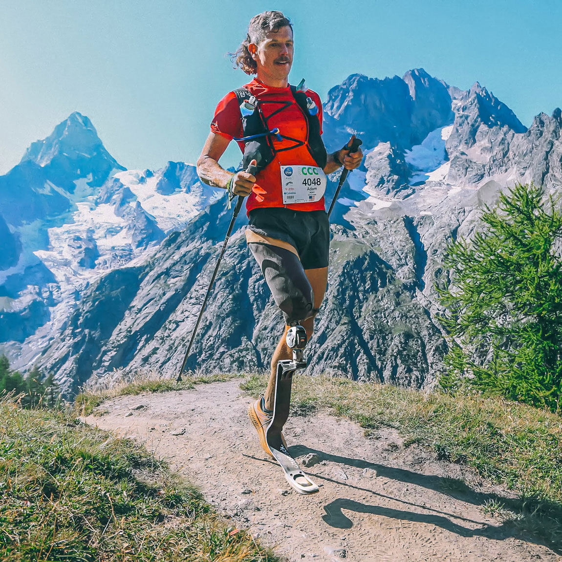 Ottobock Ambassador Adam Popp hiking on on a mountainous trail with a prosthetic running blade