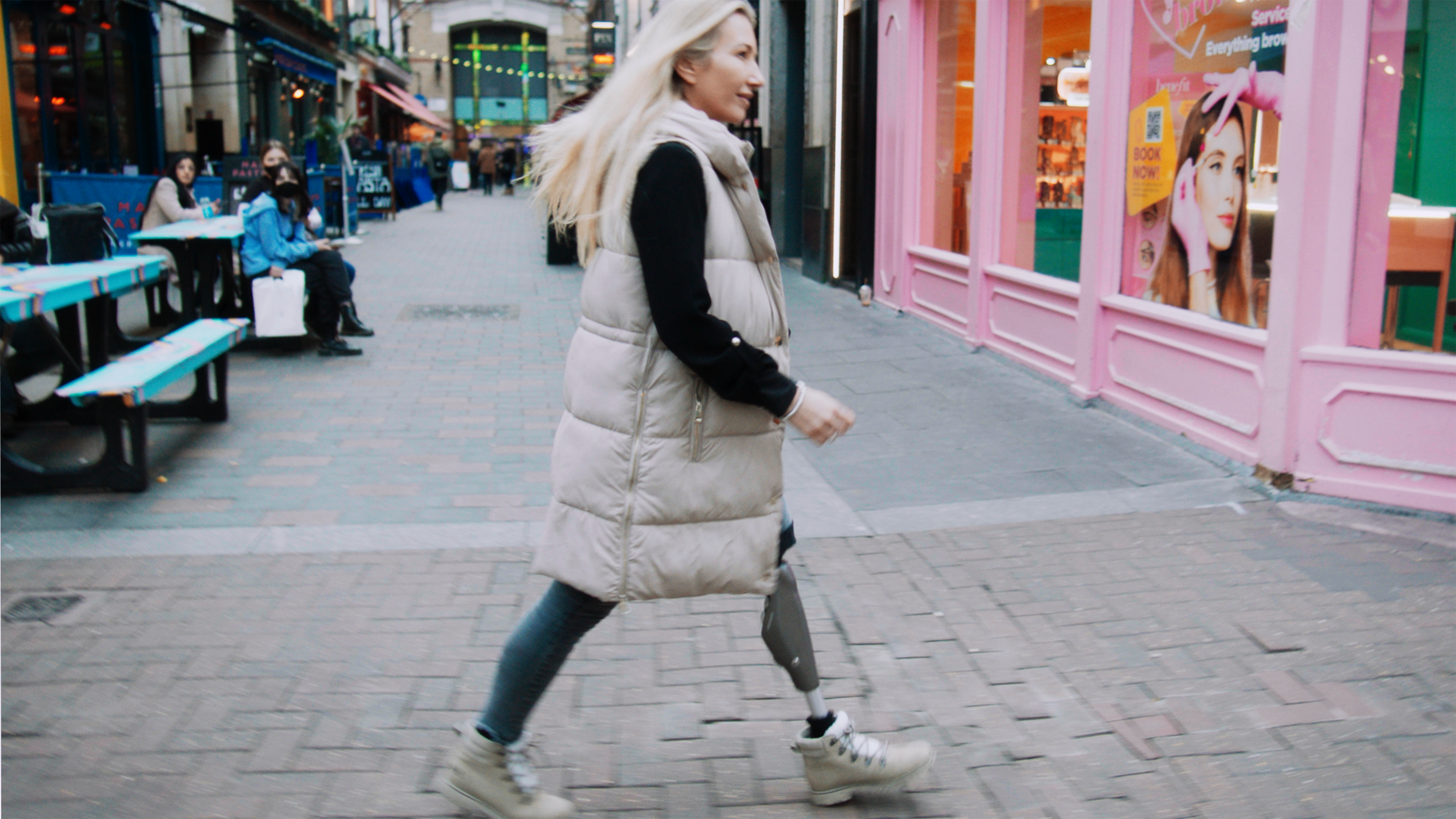 Walking in Soho London, Alt text: Rebecca is walking through London with her C-Leg.
