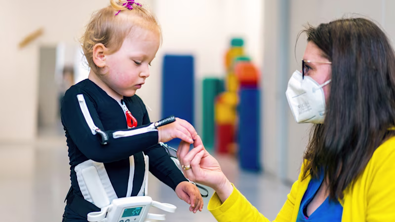 Cerebral palsy patient playing with her physiotherapist