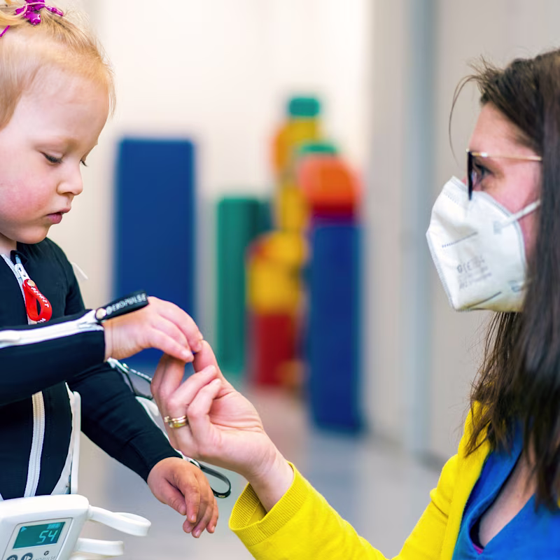 Cerebral palsy patient playing with her physiotherapist
