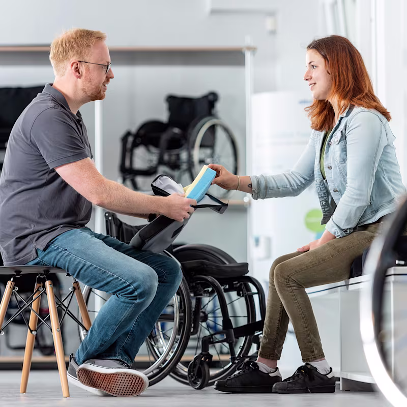 A user is advised on suitable wheelchairs by qualified personnel at the Bad Oeyhausen workshop.