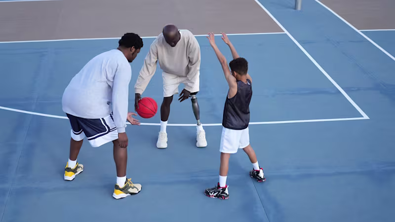 A Genium X4 prosthetic knee user is playing basketball