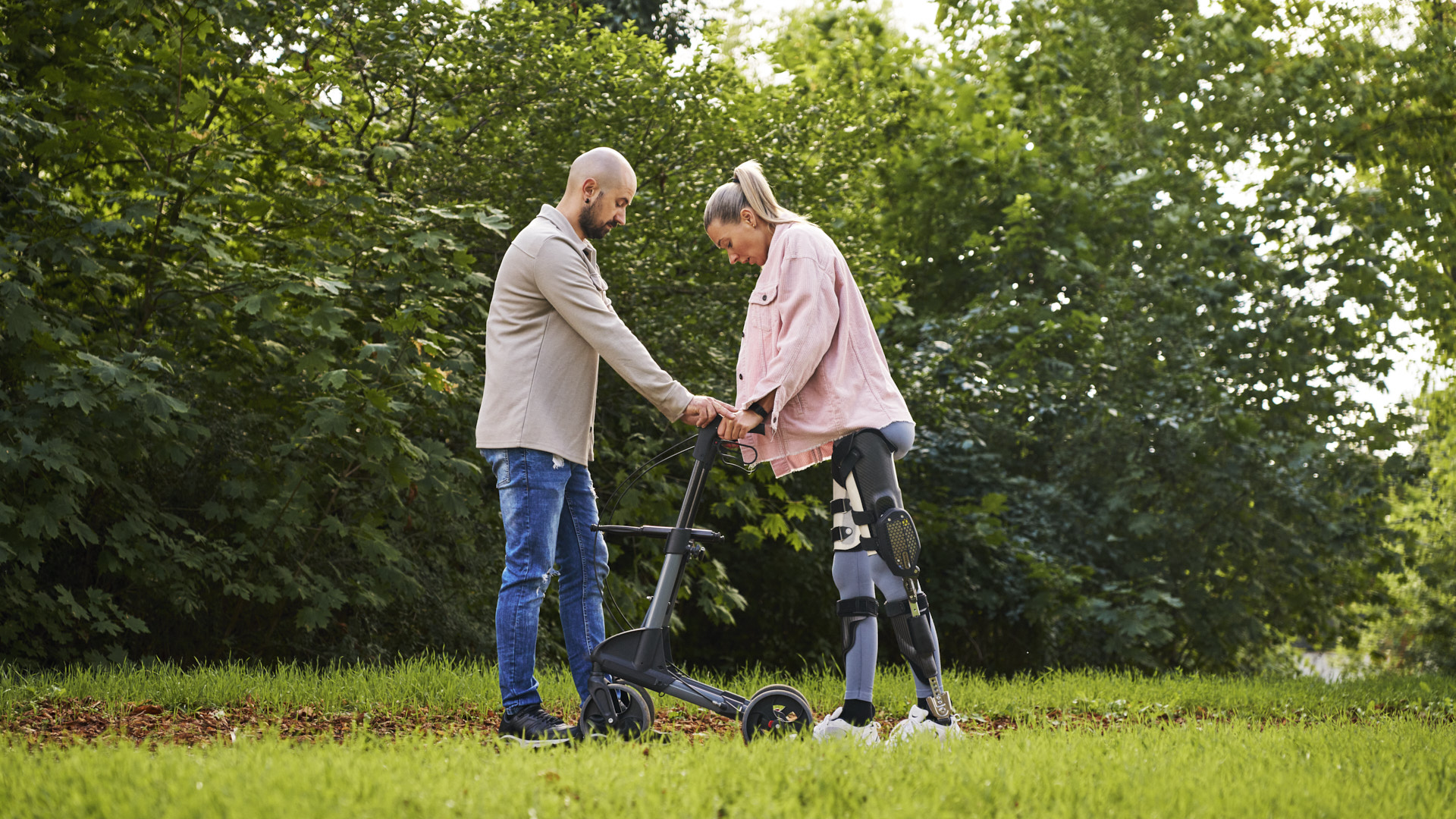 Ein Patient, der C-Brace verwendet, läuft in der Natur mit der Hilfe eines Mannes 