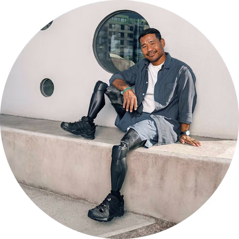 Veteran and Genium X3 user Hari Budha Magar sits on a stone step