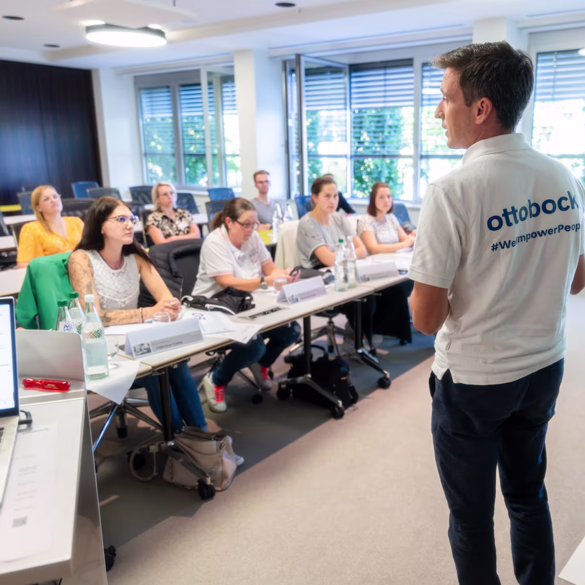 Ein Ottobock Mitarbeiter hält vor Seminarteilnehmern einen Vortrag