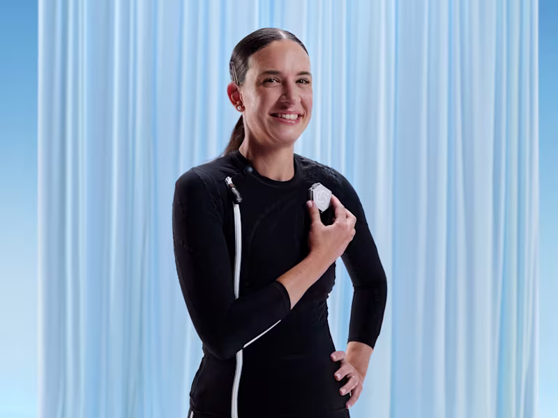 Ottobock user Jacqueline holds the exopulse suit control unit.