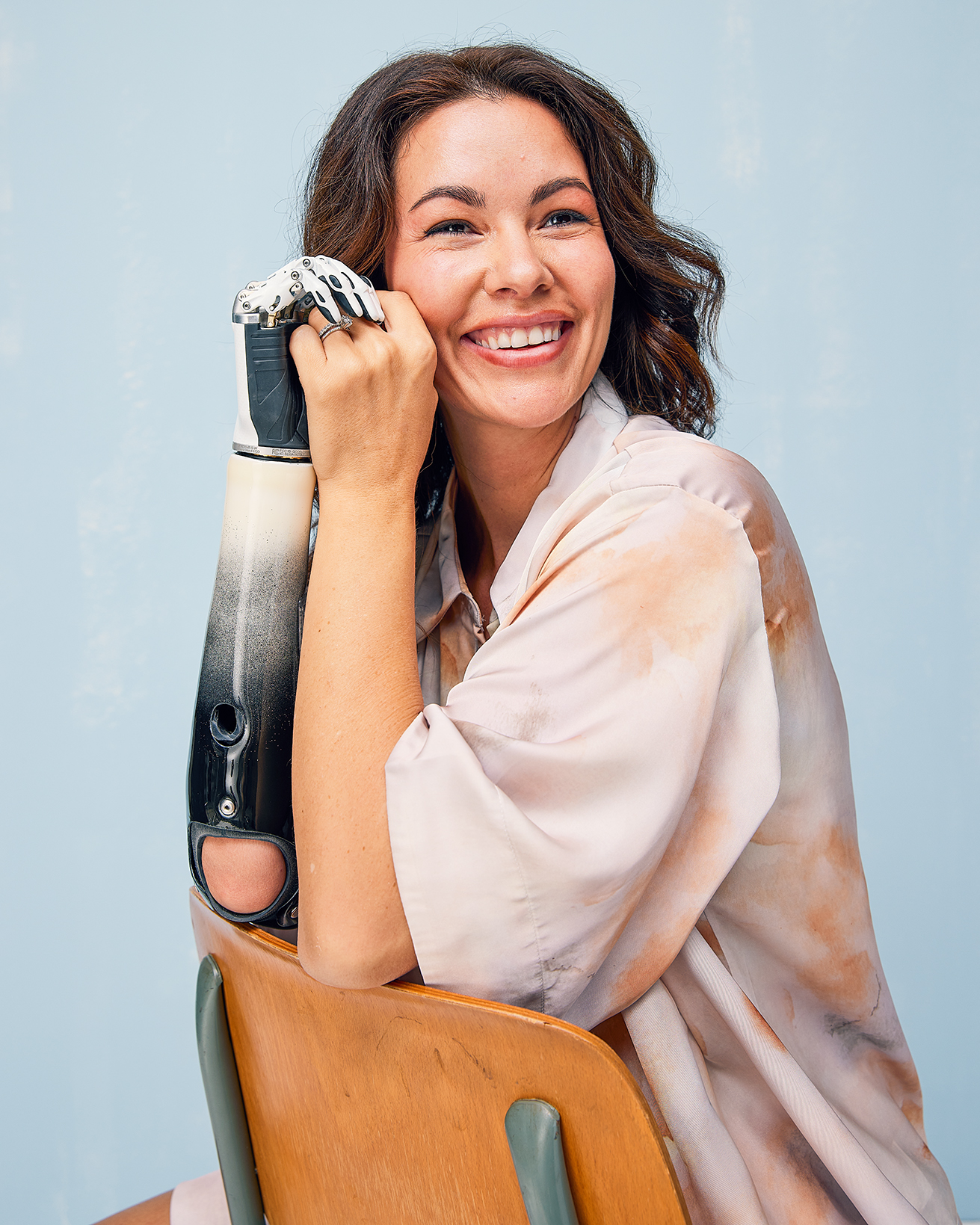 Shaholly smiling while posing with her custom Ottobock bebionic prosthetic hand.