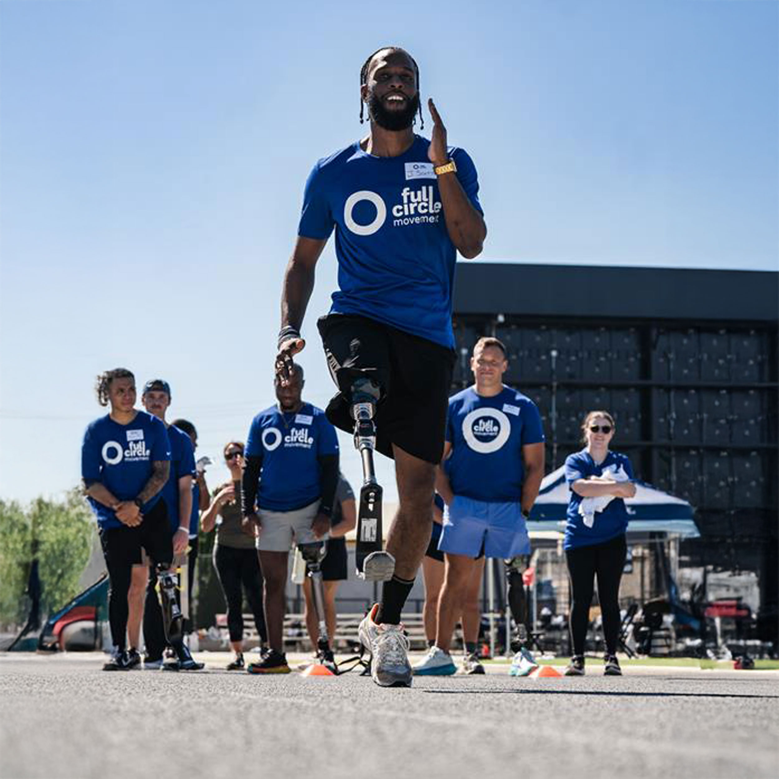 An adaptive athlete running in place with a sports prosthesis on an outdoor track