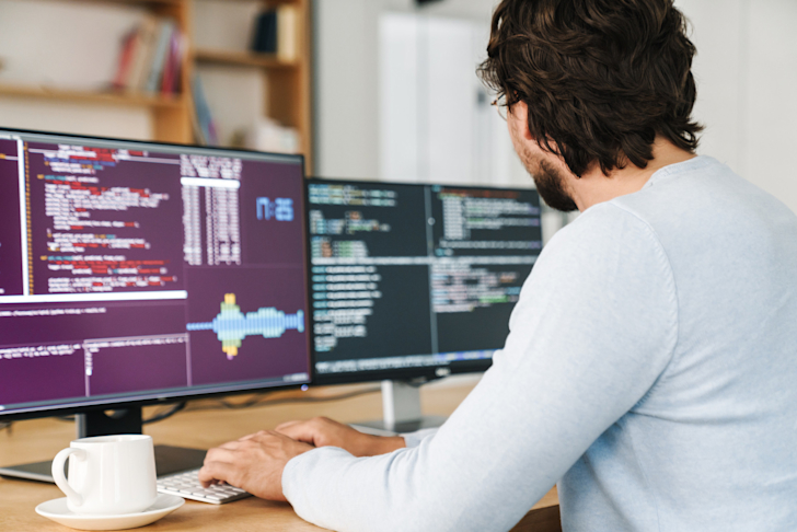 programmeren-programmeur-it-beeldschermen-kantoor-bureau