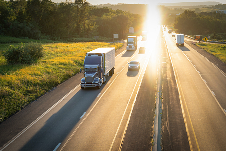 stock-photo-transportation-sunset-truck-freight-golden-hour-trucking-logistics-18-wheeler-tractor-trailer-384776c0-fb17-4800-a705-bb9ecf2dc755