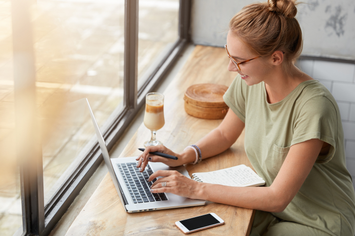 glad-successful-female-freelancer-with-hair-knot-p-2021-08-31-08-27-32-utc