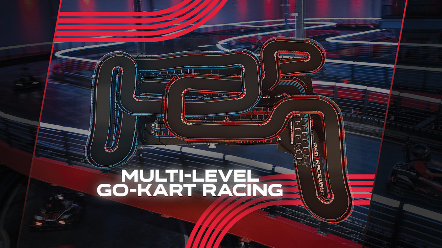 Overhead view of RPM Oakbrook’s multi-level indoor go-kart track, featuring winding courses outlined in red and blue lighting against a dark, neon-lit racing venue.