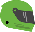 A green motorcycle helmet with a dark grey visor. The helmet has a sleek, aerodynamic design and a small black circle near the front, likely representing a vent or logo.