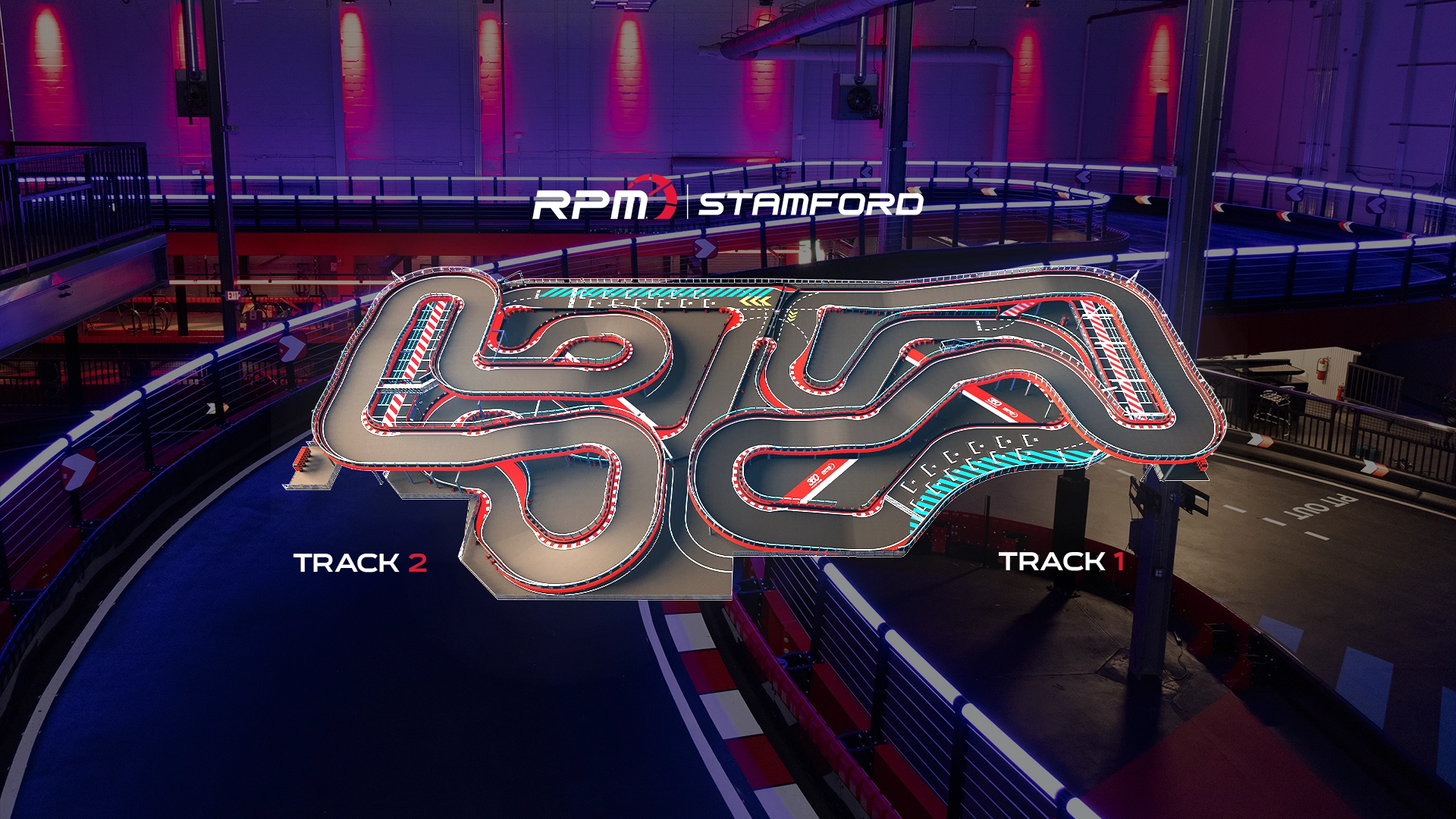 A complex indoor go-kart track with multiple winding turns, lit under blue and red lights. The track layout features several straightaways and sharp corners, designed for a challenging racing experience. The background includes part of the racing facility with additional lighting.