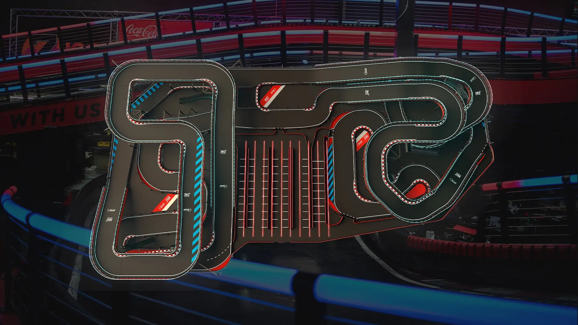 An intricate indoor go-kart racing track with various winding routes and sharp turns is displayed. The track is illuminated with bright red and blue lights, and a portion of a neon-lit barrier is visible in the foreground.