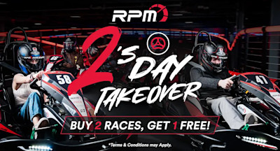 Two people racing go-karts indoors, wearing helmets and race suits, with dramatic lighting and red accents. The text "RPM – Race Play More 2's Day Takeover Buy 2 races, get 1 free! *Terms & Conditions may Apply" is displayed prominently in the image.