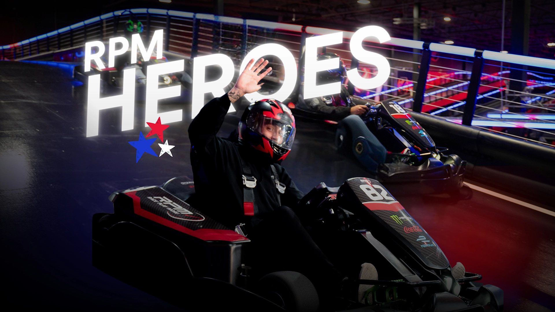 Two go karts on a go kart track with a rider waiving at the camera and the text RPM Heroes imposed over.