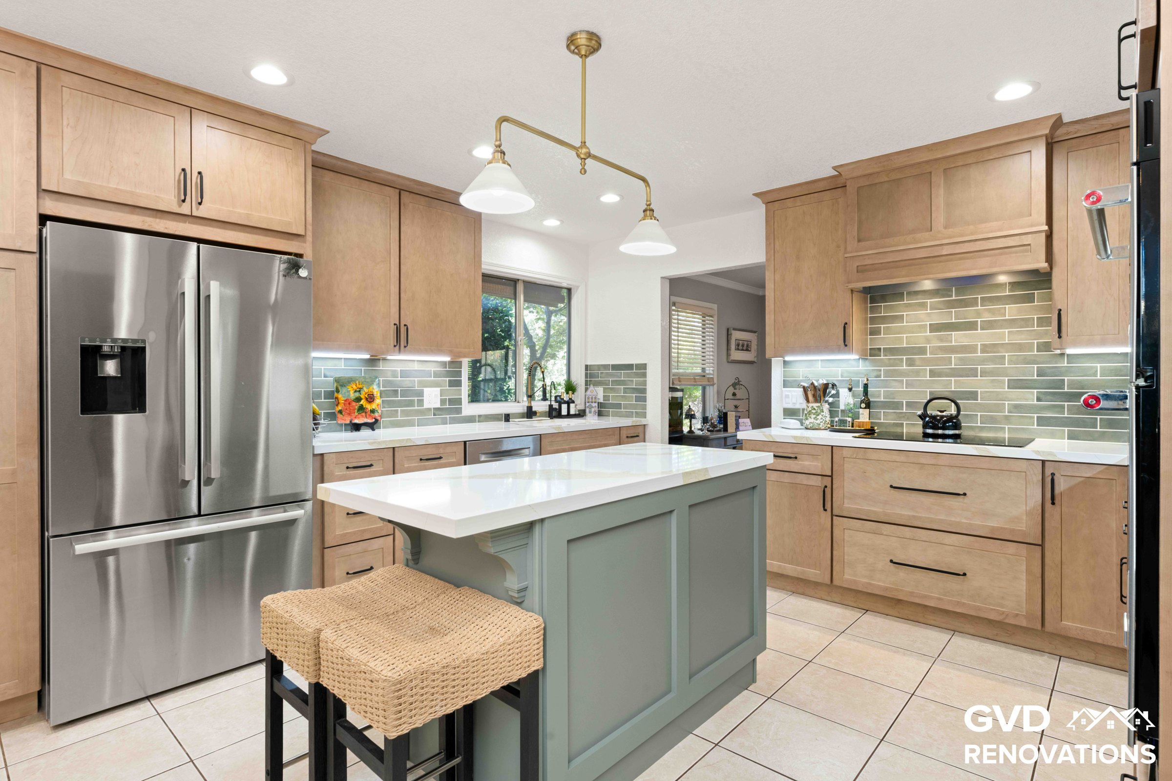 Sage green kitchen island with a Calacatta quartz countertop and counter-height seating