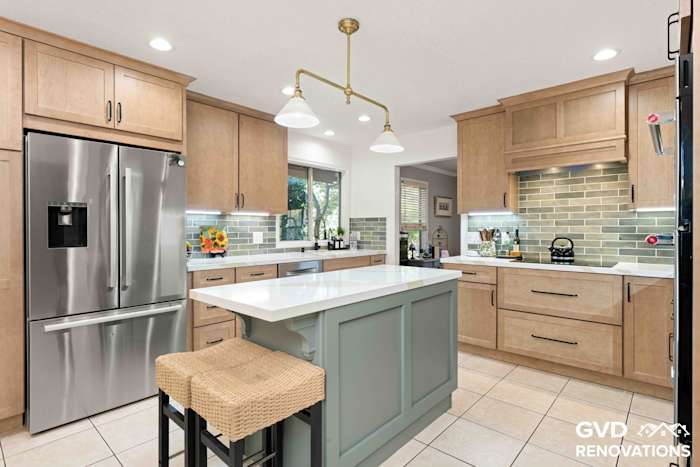 Sage green kitchen island with a Calacatta quartz countertop and counter-height seating