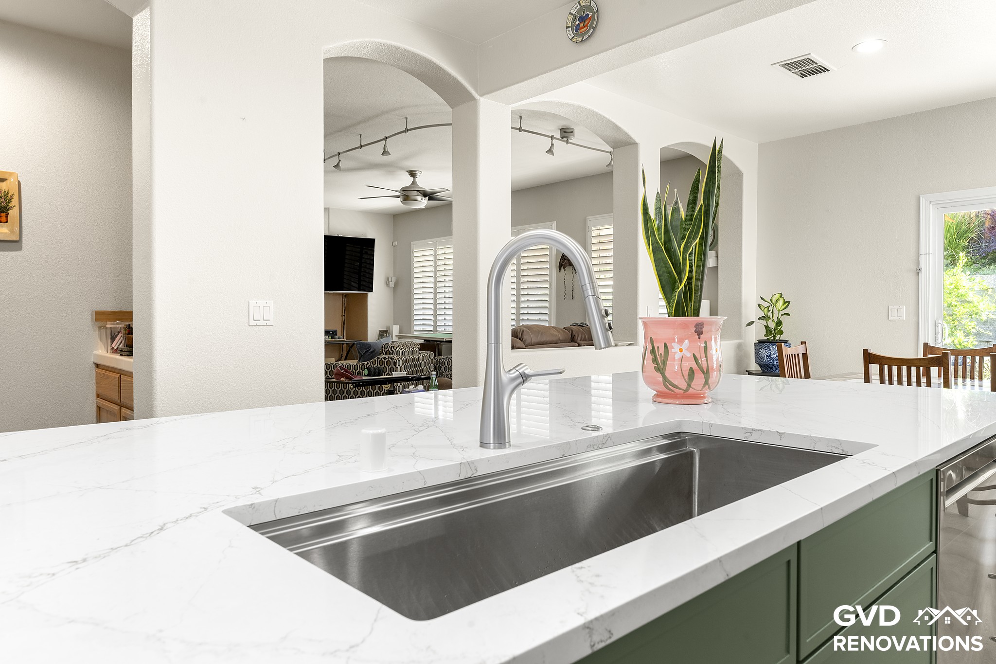 Island prep sink with a stainless undermount basin and a spring-neck faucet on a quartz countertop