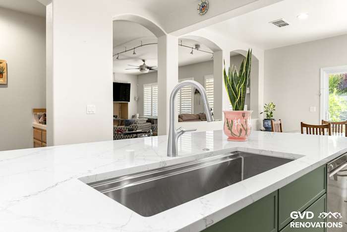 Island prep sink with a stainless undermount basin and a spring-neck faucet on a quartz countertop