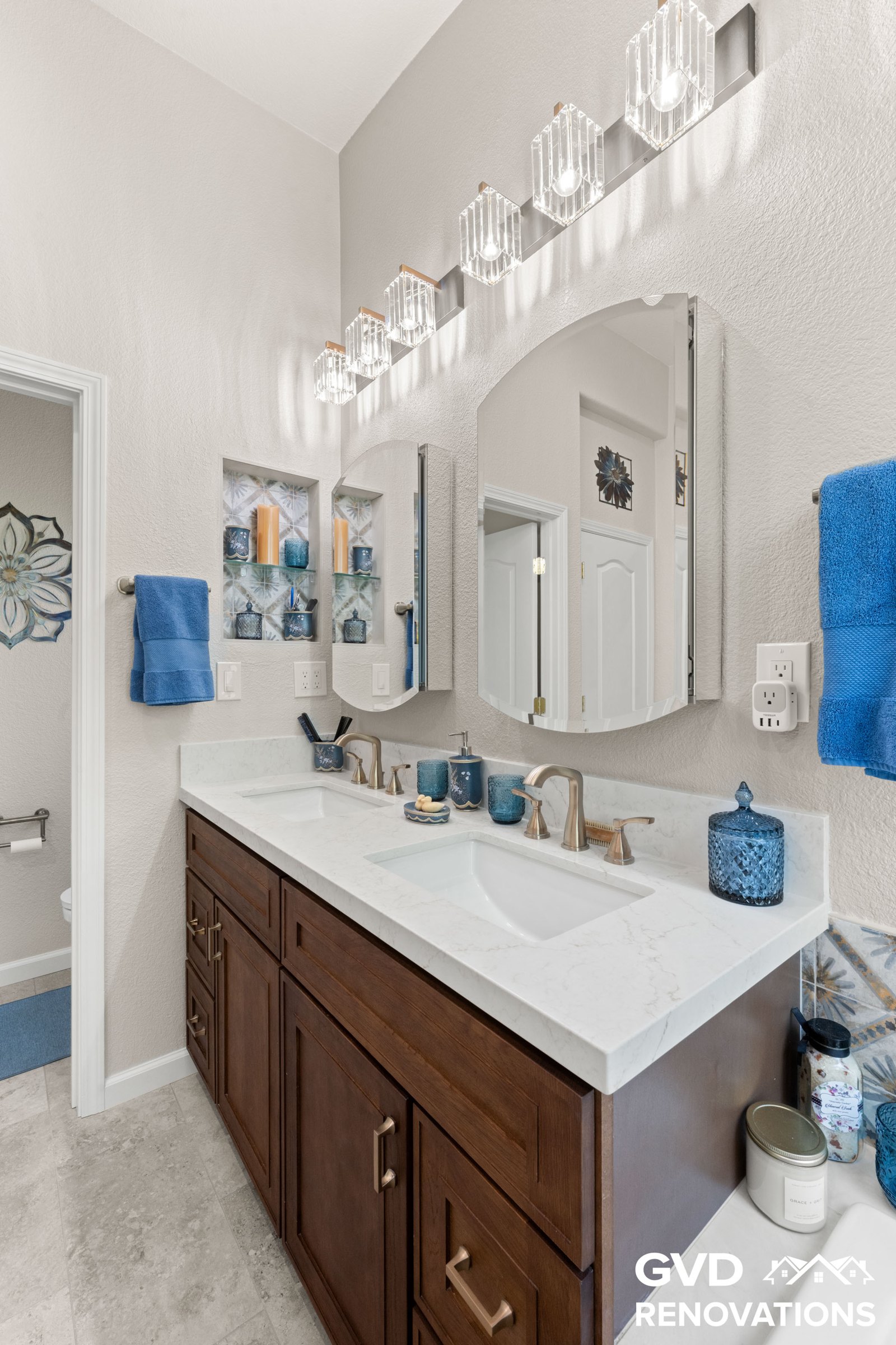 Bathroom vanity with a quartz countertop, undermount sink and framed mirror