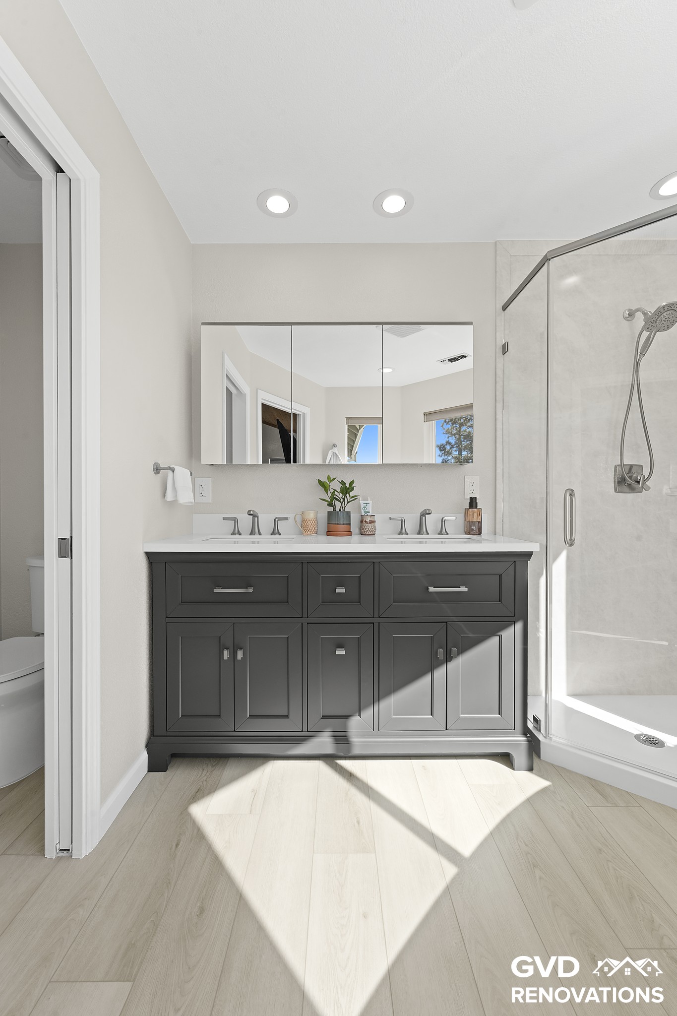 Charcoal double vanity with a framed mirror and matte-black fixtures