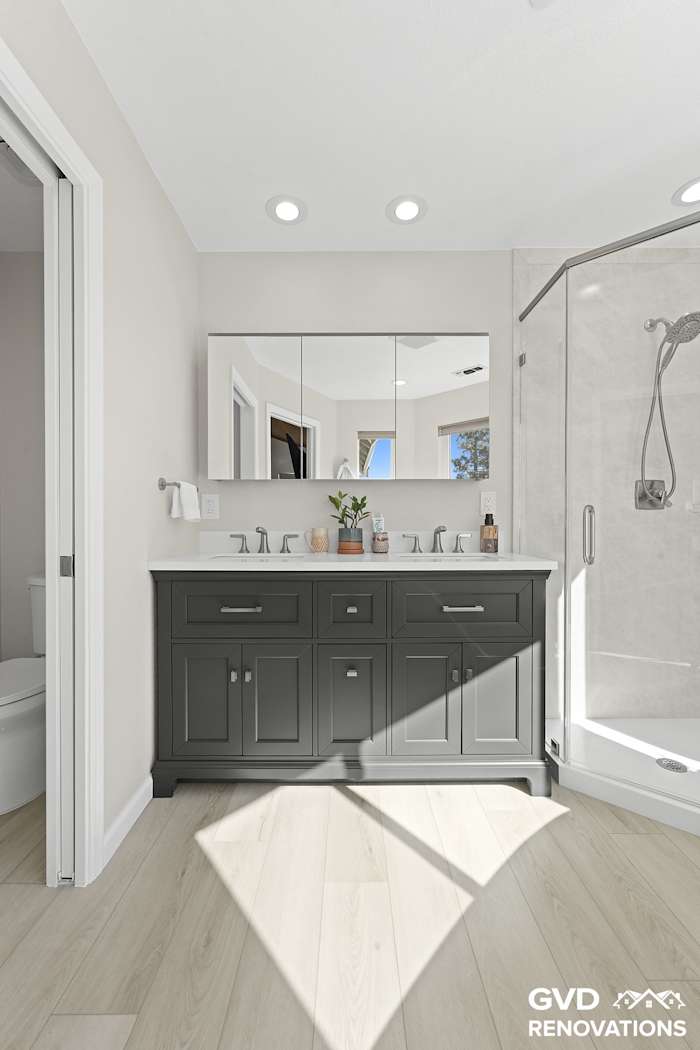 Charcoal double vanity with a framed mirror and matte-black fixtures