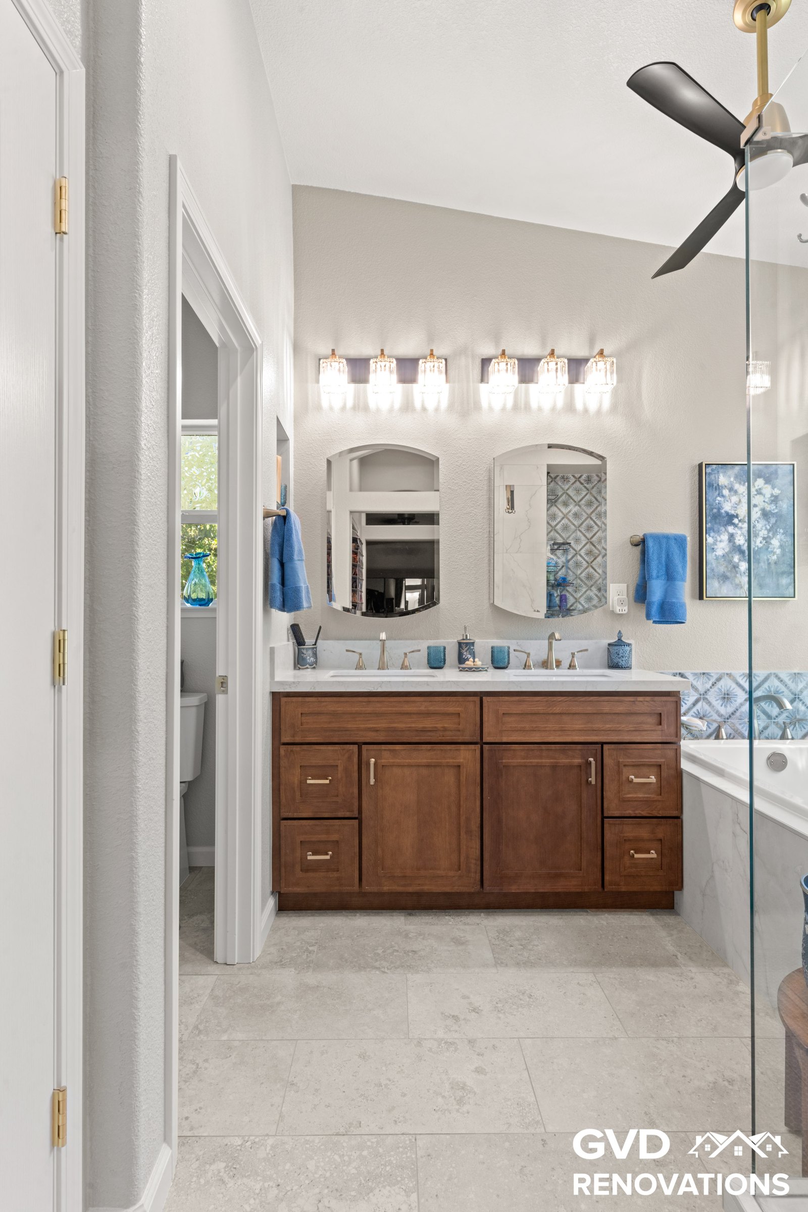Bathroom vanity and mirror viewed from the entry doorway