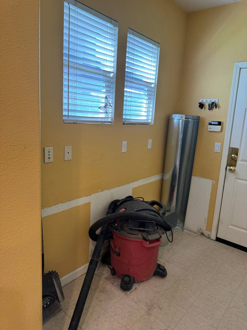 Before: original window wall and breakfast nook area with yellow walls before the kitchen remodel
