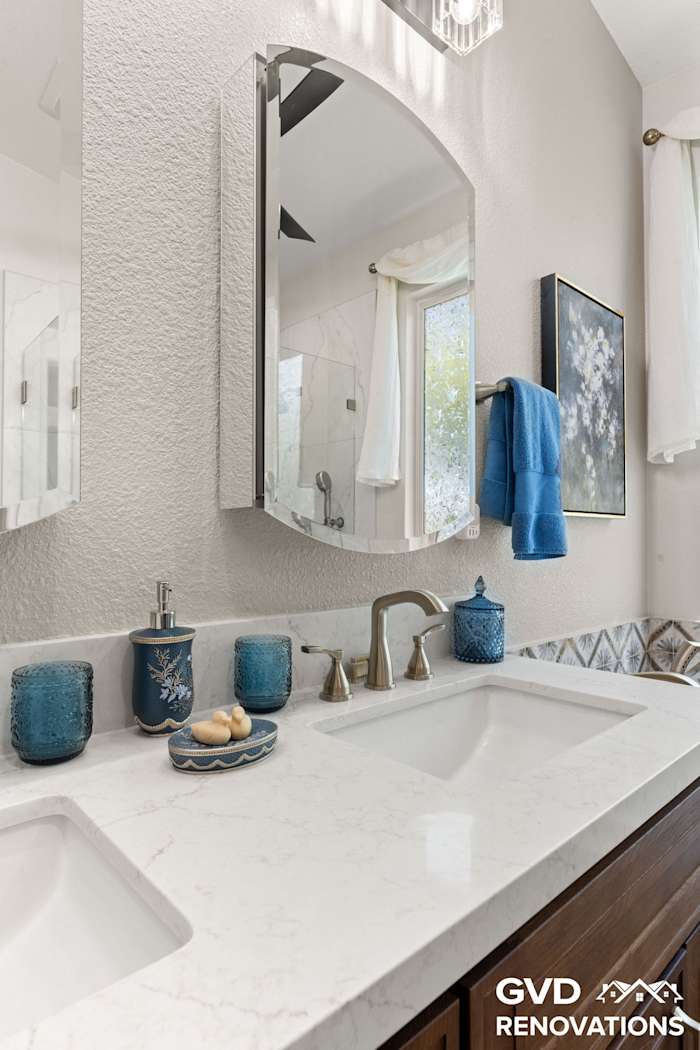Wood double vanity with two undermount sinks, quartz countertop and a large mirror