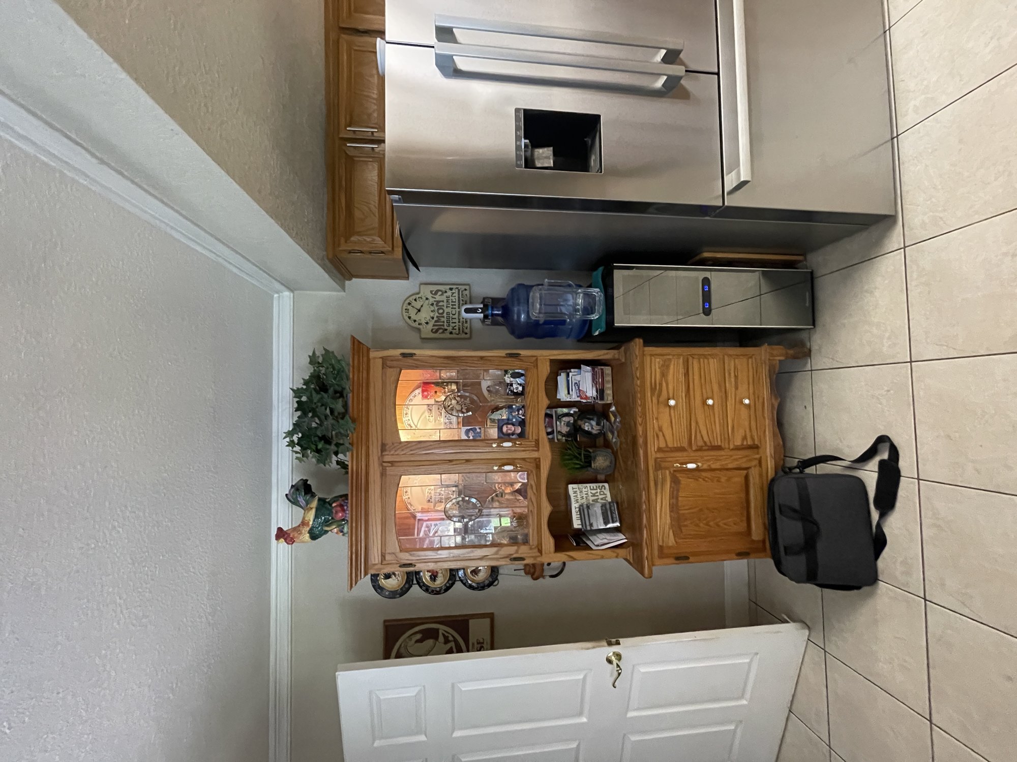 Before: original oak hutch and beverage area with a water cooler