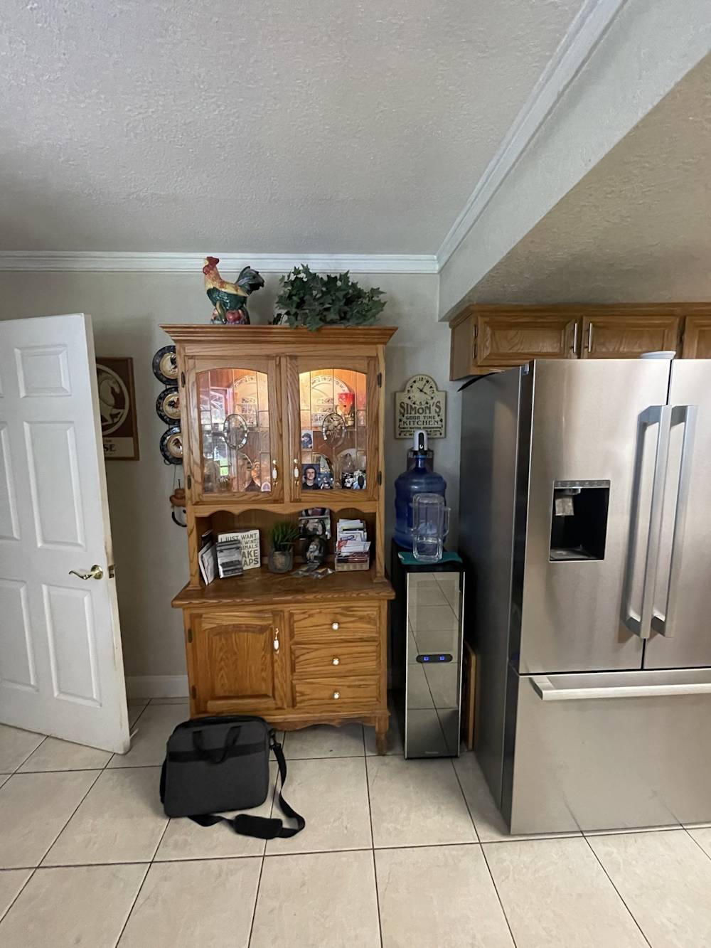 Before: original oak hutch and beverage area with a water cooler