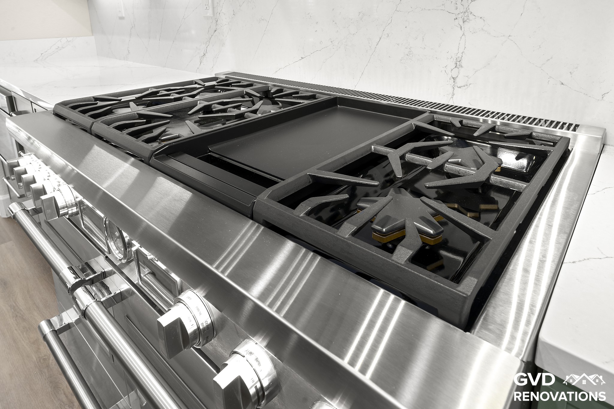 Close-up of the professional stainless gas range cooktop with multiple burners