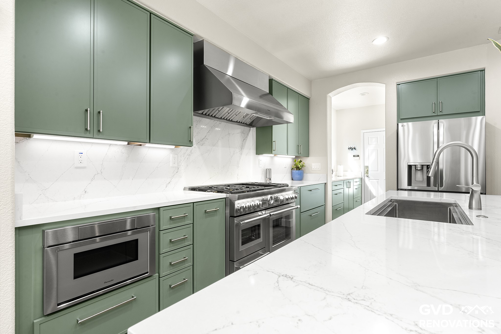 Range wall with a custom hood, microwave drawer and under-cabinet LED lighting