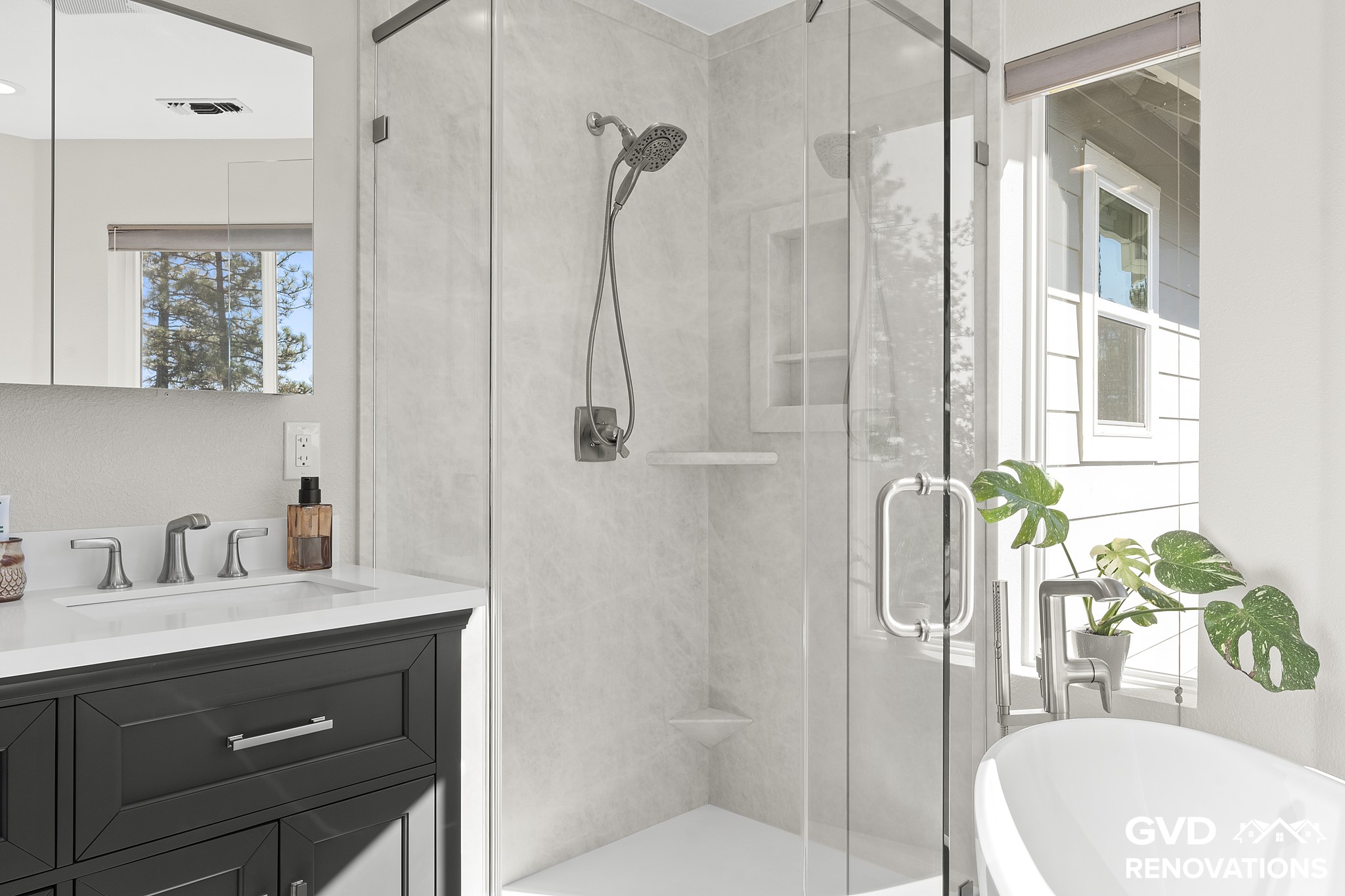 Marble-look neo-angle walk-in shower beside the charcoal vanity