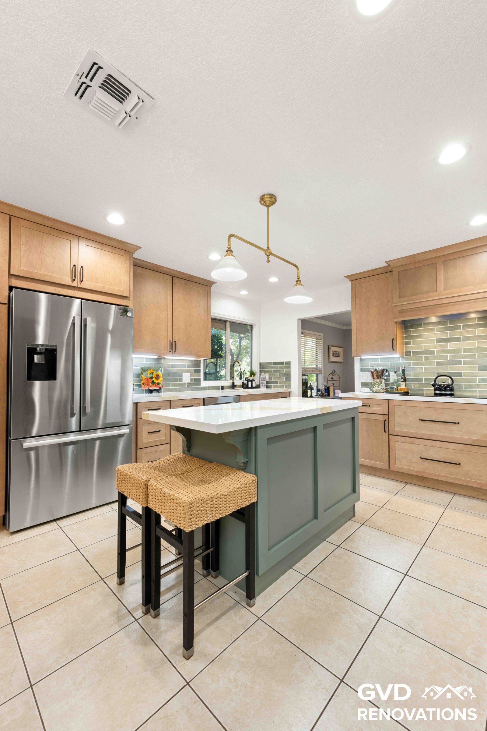 Kitchen island with woven counter stools, a quartz top and natural maple Shaker cabinets