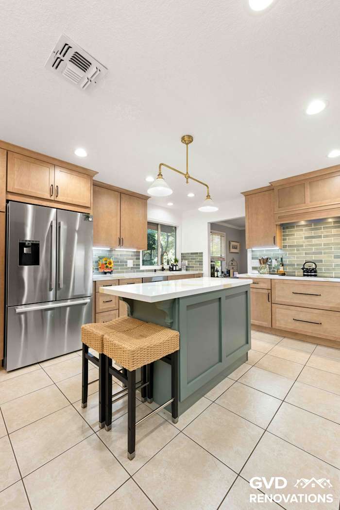 Kitchen island with woven counter stools, a quartz top and natural maple Shaker cabinets