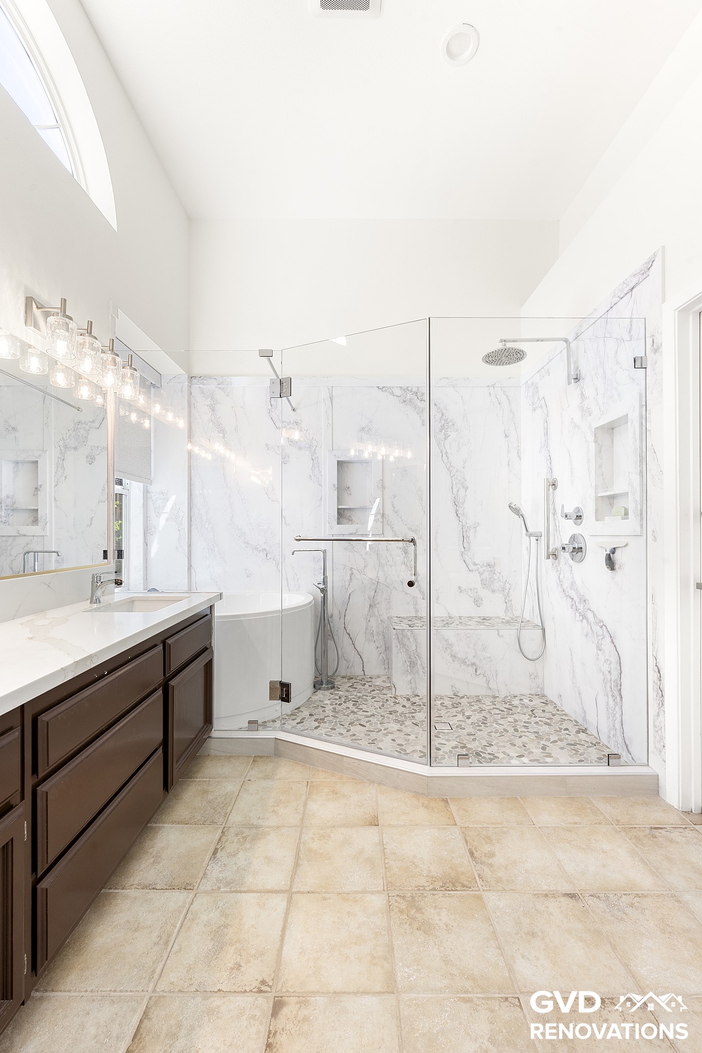Wide view of the remodeled master bathroom with a double vanity, soaking tub and walk-in shower