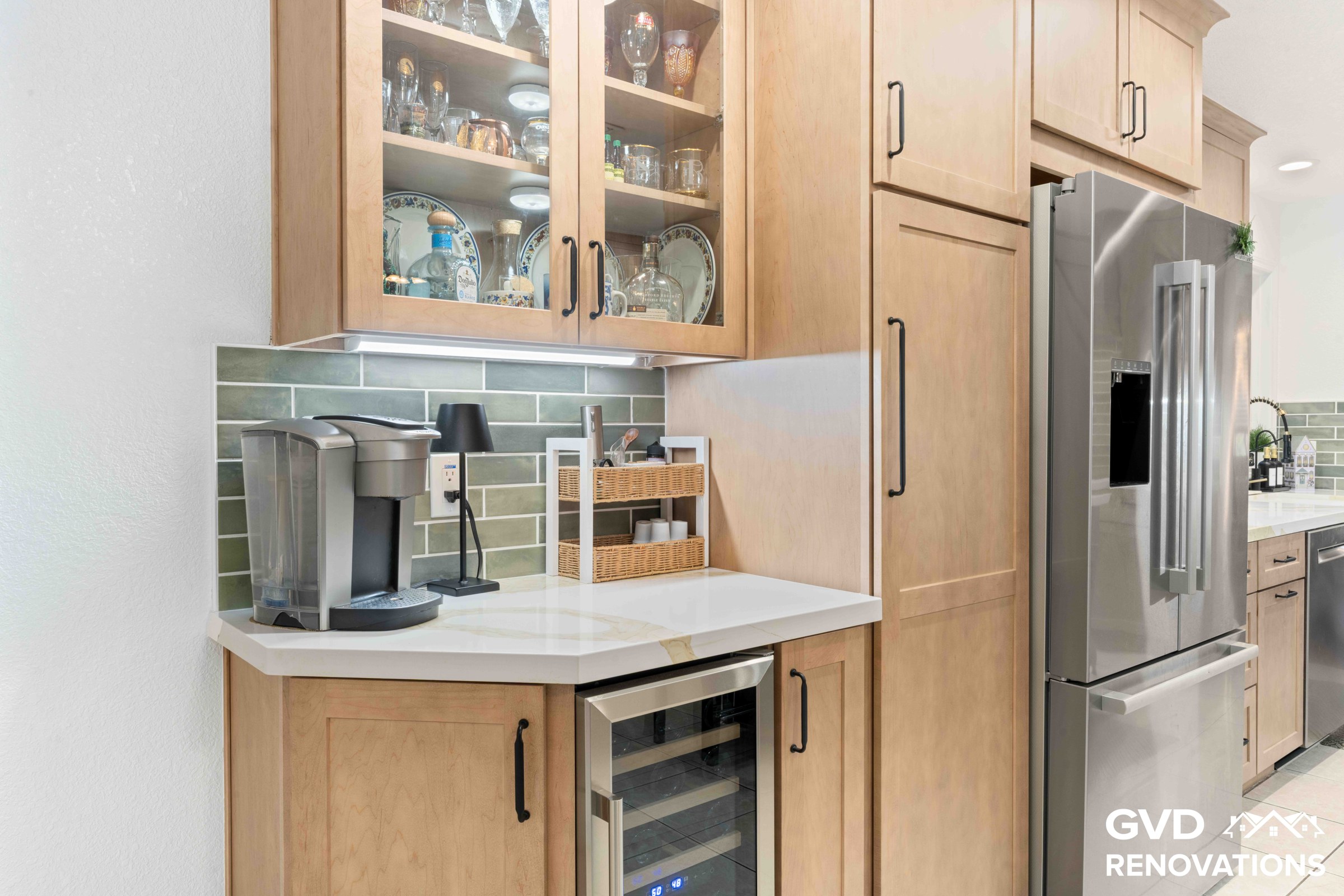 Kitchen coffee and beverage station with glass-front maple Shaker cabinets, Calacatta quartz countertop, built-in wine refrigerator and stainless steel French-door refrigerator