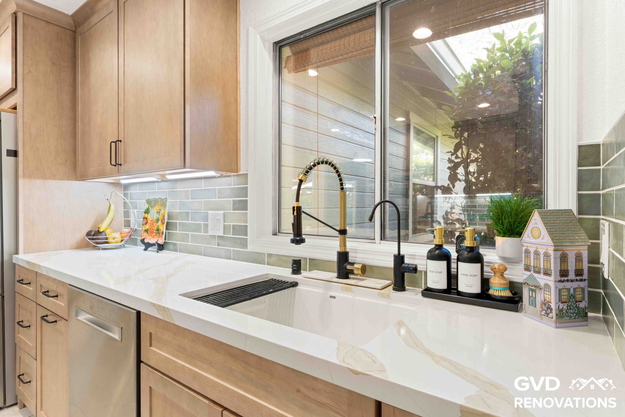 Kitchen prep area with a stainless dishwasher, undermount sink, window and green glass subway tile backsplash