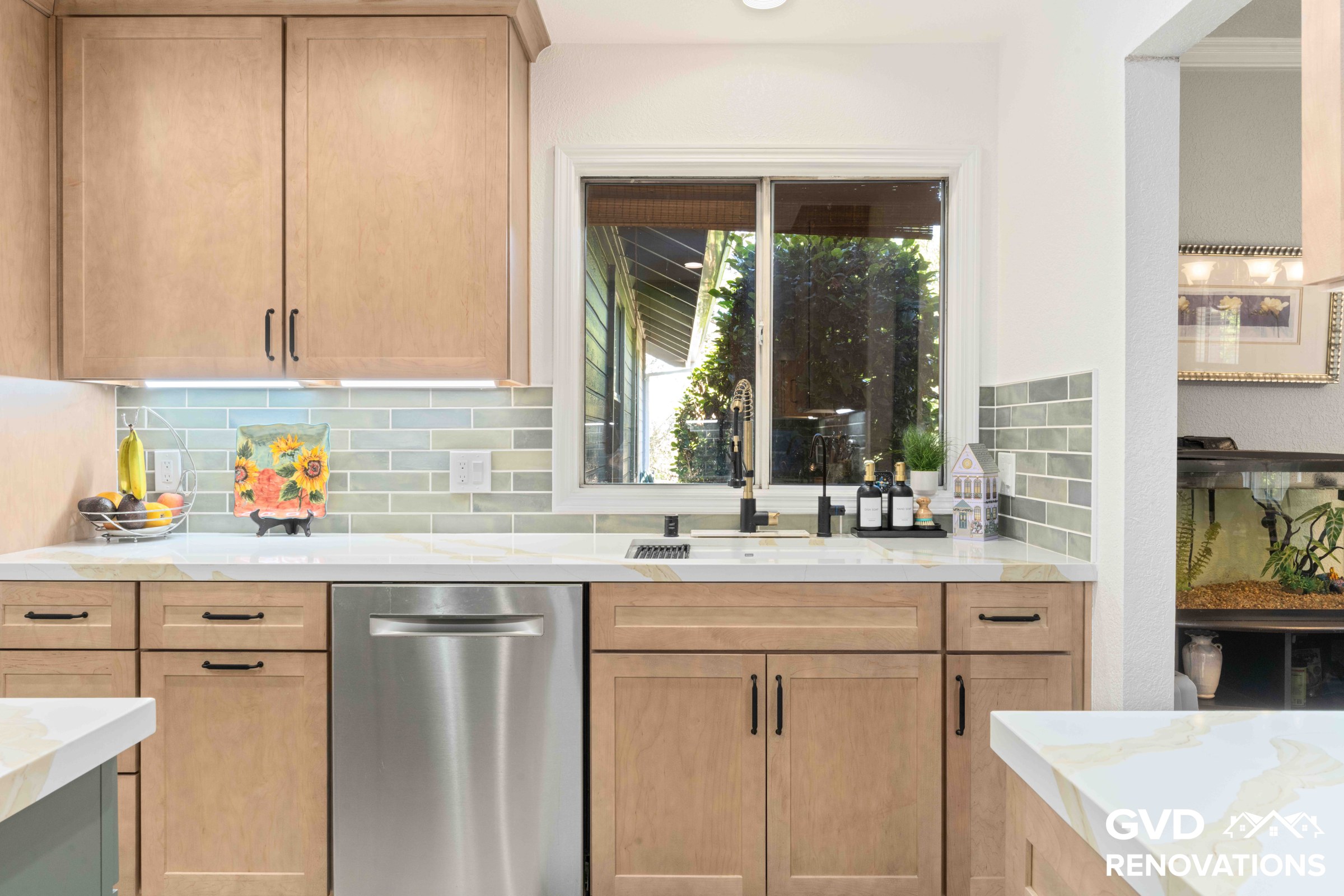 Maple Shaker cabinets with a stainless steel dishwasher, quartz countertops and a window above the counter