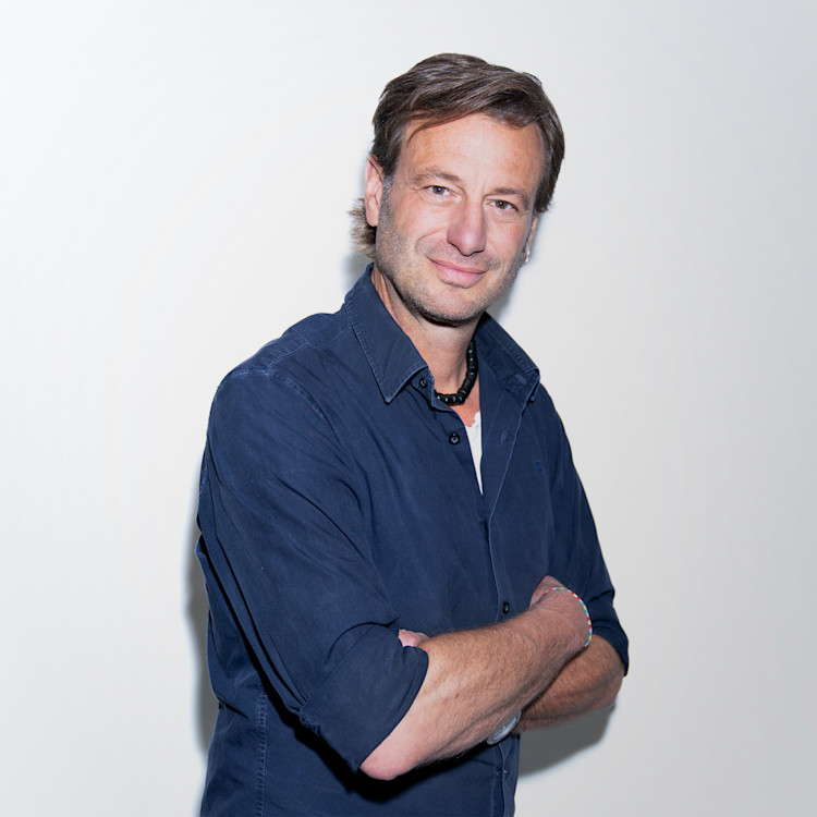 About | Quote | Florian Liebold Florian Liebold standing center with arms folded looking to camera