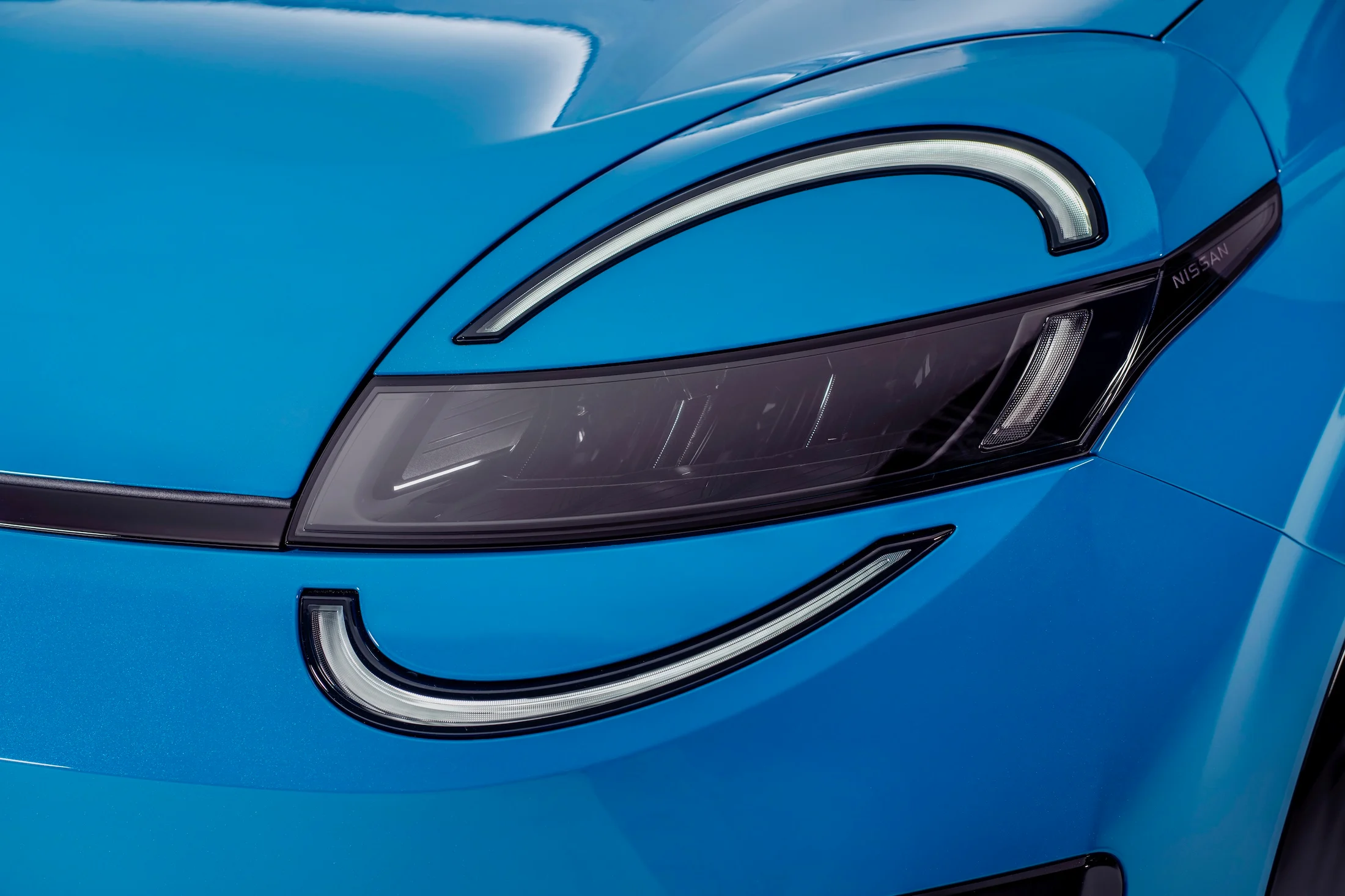 detailed shot of signature micra headlamps on blue body with led lights on