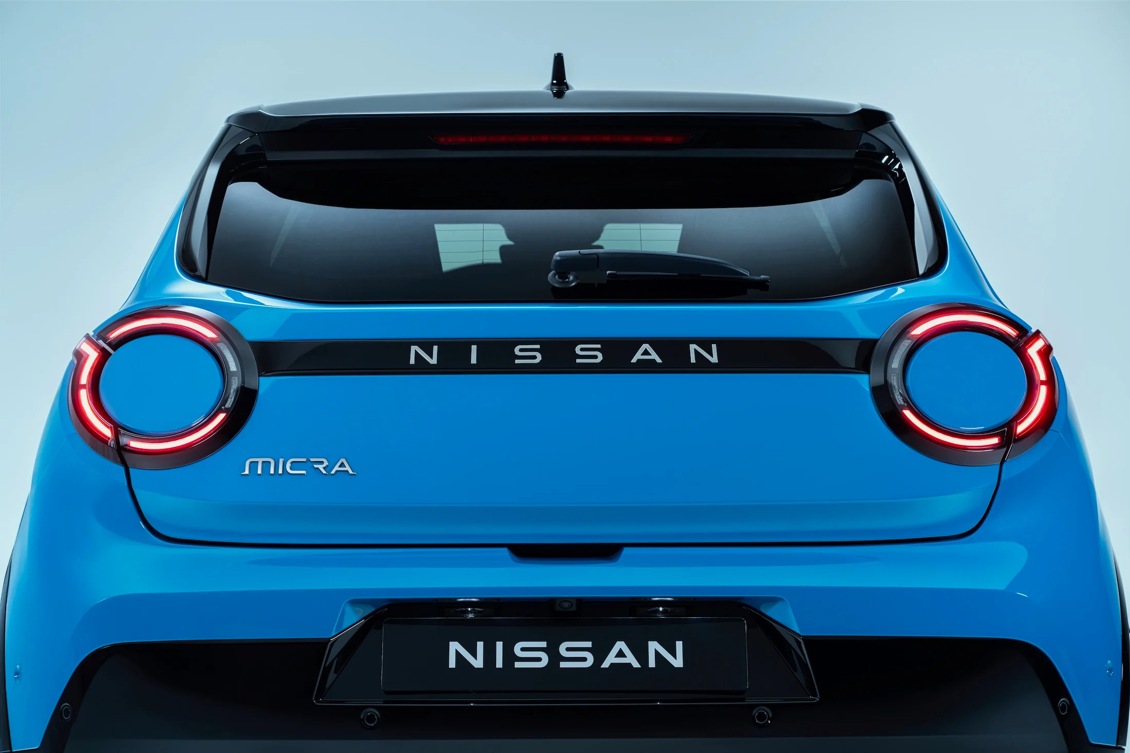 Rear view of Micra showing rear headlamps, Micra logo, Nissan logo and trunk door