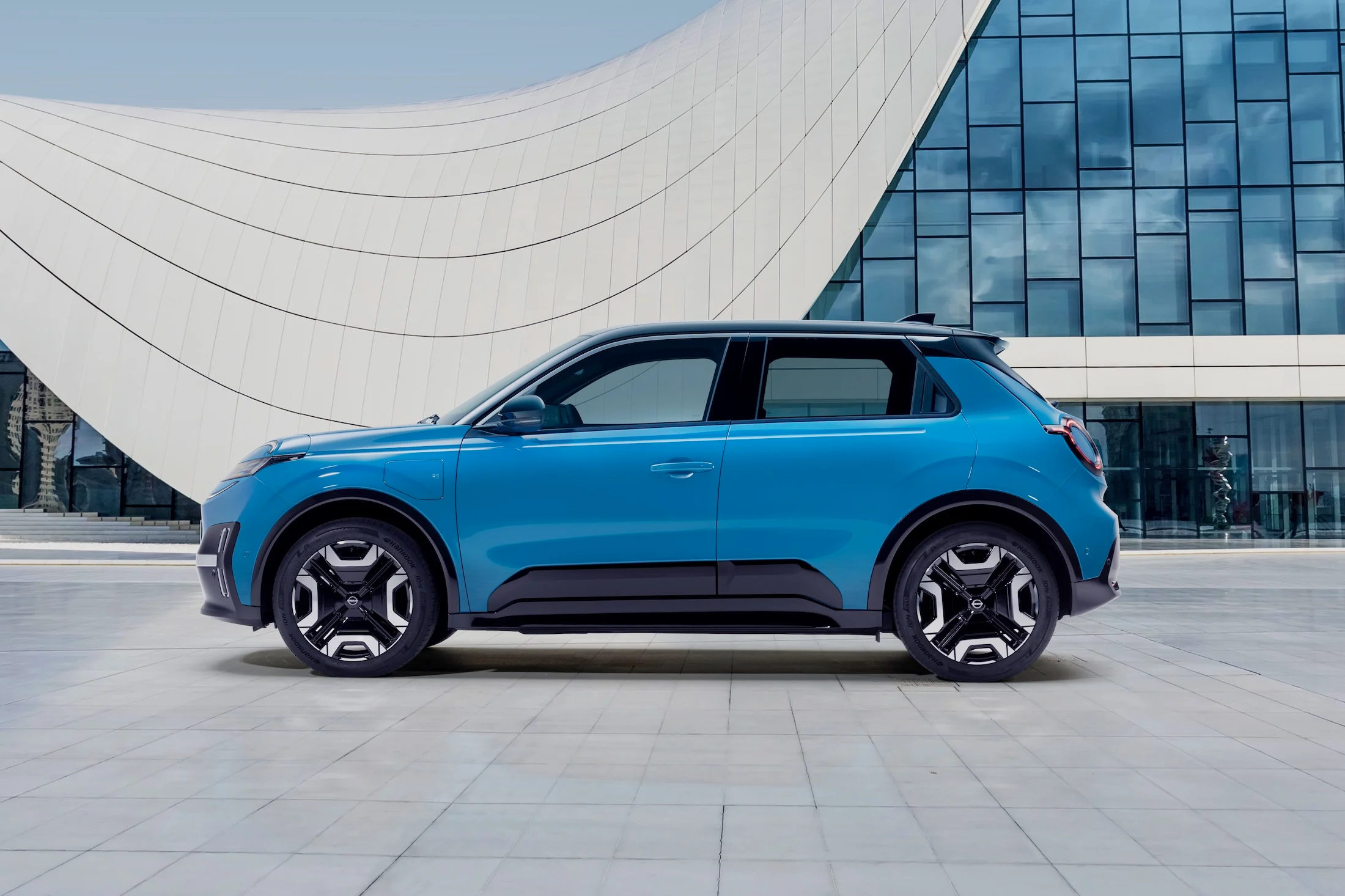 Hero image of gear blue Micra profile against a design architectural building