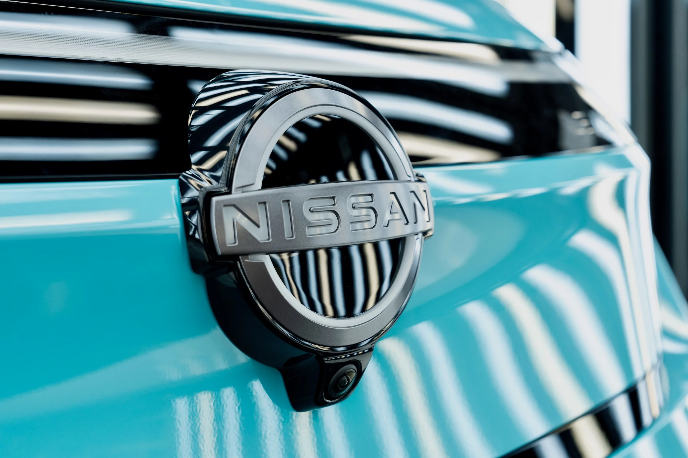 A Nissan badge on a Nissan LEAF